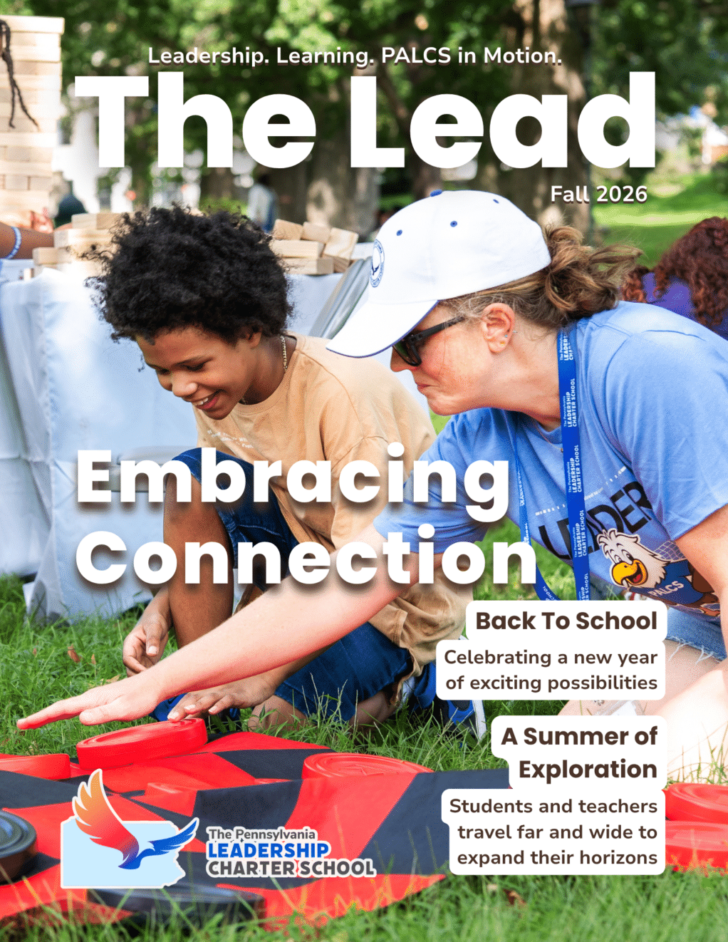 The front cover of the Fall 2026 edition of The Lead. The image is of a PALCS staff member and a PALCS student playing a yard game. The cover says "Embracing Connection." Additional headlines say "Back To School Celebrating a year of exciting possibilities" and "A summer of exploration: students and teachers travel far and wide to expand their horizons"
